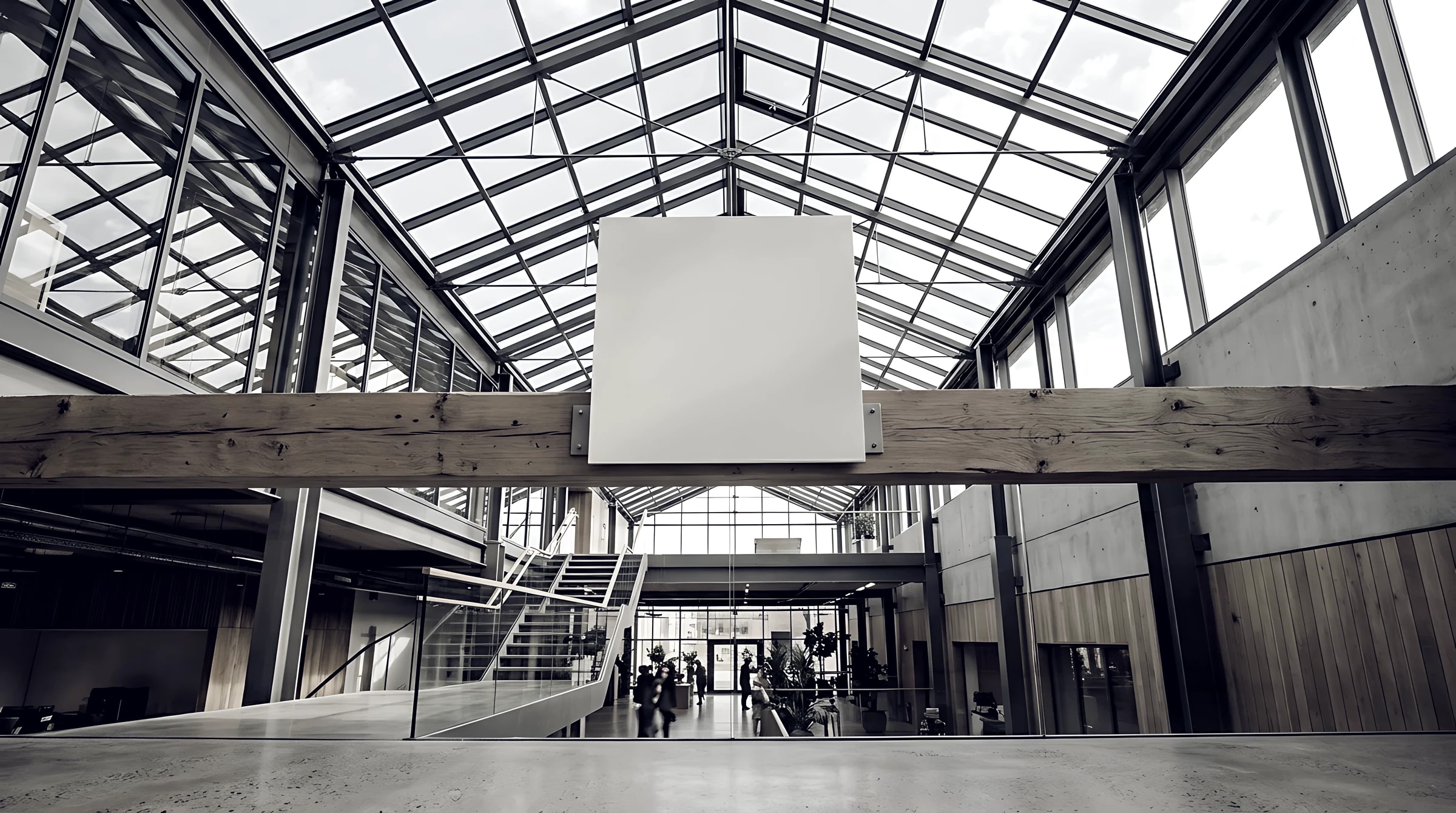 Glass-roofed commercial atrium with exposed structural framing