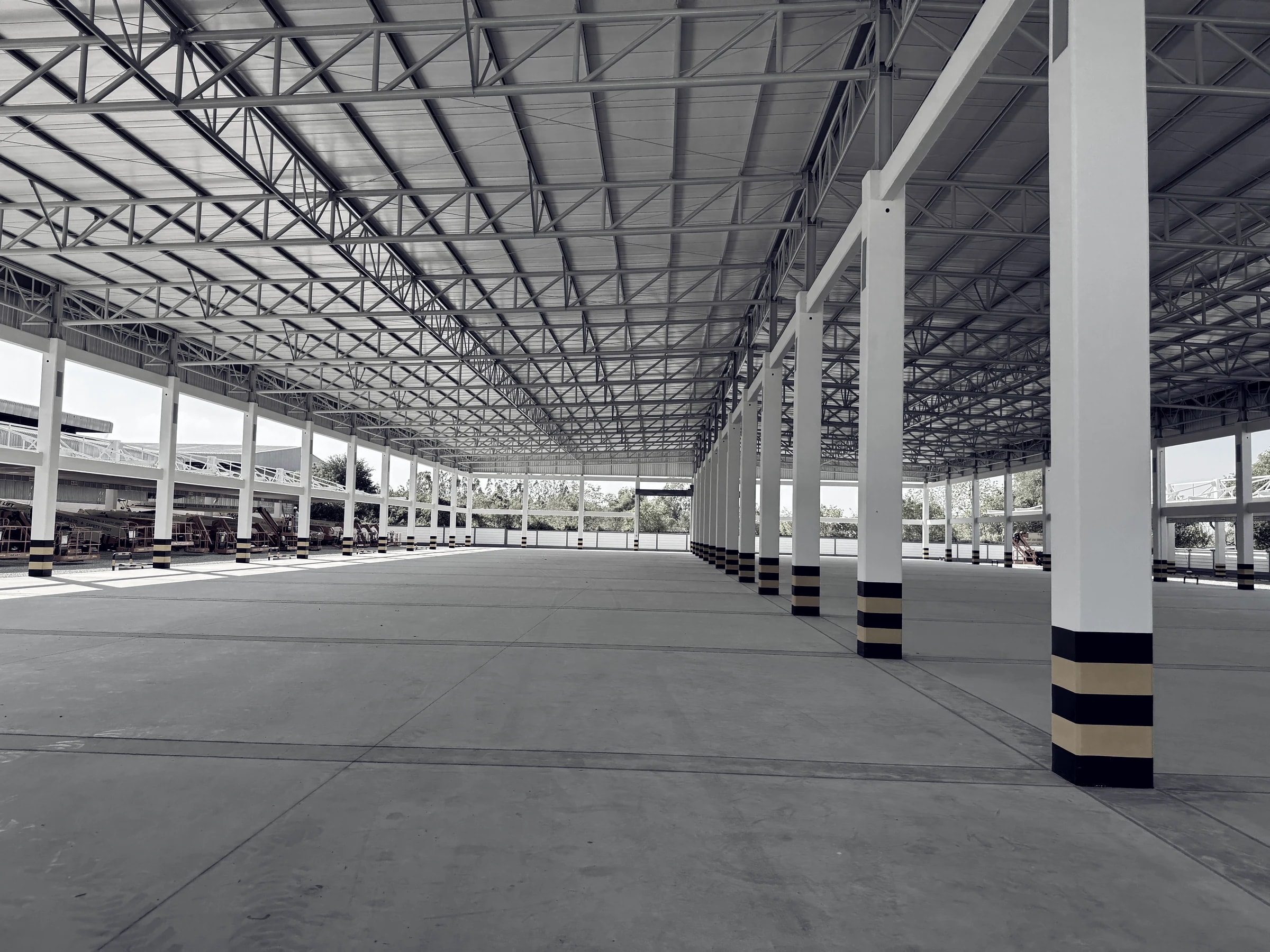 Large industrial hall with steel roof trusses and structural columns